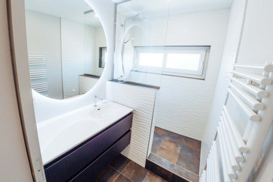 This is an example of a small contemporary 3/4 bathroom in Bordeaux with white tile, ceramic tile, grey walls, ceramic floors, a wall-mount sink, solid surface benchtops, multi-coloured floor, an open shower, white benchtops and a single vanity.