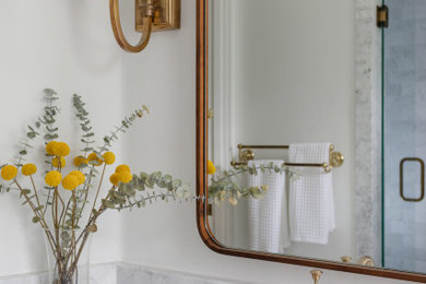 Trendy white tile double-sink bathroom photo in Dallas with white cabinets, marble countertops and gray countertops