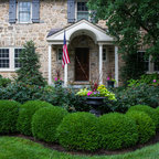 A greenhouse, barn and vegetable garden