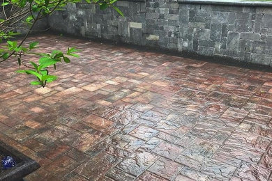 Mid-sized transitional backyard patio in DC Metro with stamped concrete and no cover.