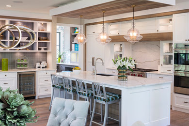 Inspiration for a large transitional single-wall eat-in kitchen in Minneapolis with an undermount sink, shaker cabinets, white cabinets, marble benchtops, white splashback, stone slab splashback, stainless steel appliances, dark hardwood floors and with island.