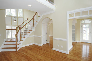 Large elegant light wood floor and black floor great room photo in Orange County with beige walls and no fireplace