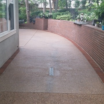 Exposed Aggregate patio with brick border.