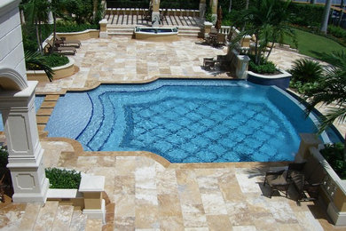 Example of a large tuscan backyard rectangular infinity pool fountain design in Miami