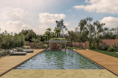 Imagen de piscina moderna grande en patio con adoquines de piedra natural