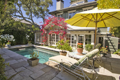 This is an example of a small traditional backyard rectangular pool in San Francisco with natural stone pavers.