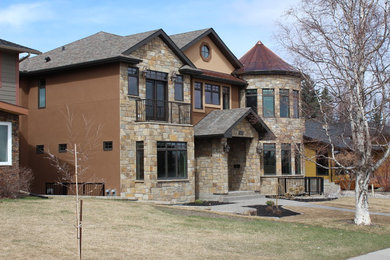 Large eclectic brown two-story mixed siding exterior home idea in Calgary