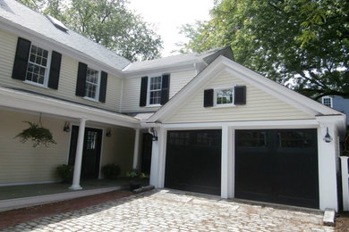 Example of a large classic white two-story wood gable roof design in Manchester