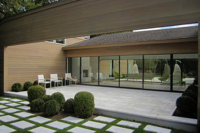 Mid-sized contemporary one-storey beige exterior in New York.