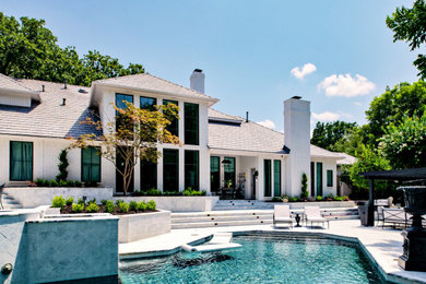 Photo of a large transitional two-storey brick white house exterior in Dallas with a tile roof.