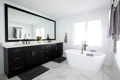 Mid-sized master ceramic tile and double-sink bathroom photo in Charlotte with black cabinets, an undermount sink, quartz countertops, white countertops, a niche and a built-in vanity