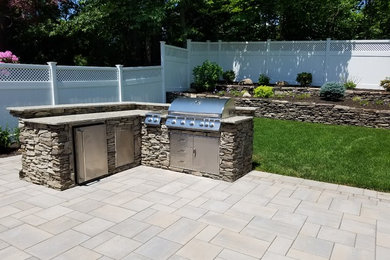 Design ideas for a backyard patio in New York with an outdoor kitchen.