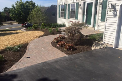This is an example of a mid-sized traditional full sun front yard brick garden path in Philadelphia.