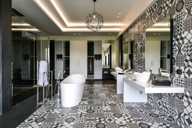 Design ideas for a large modern master bathroom in New York with flat-panel cabinets, white cabinets, a freestanding tub, black and white tile, cement tile, cement tiles, a vessel sink, engineered quartz benchtops and multi-coloured floor.