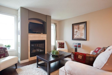 Living room - small transitional enclosed laminate floor living room idea in Calgary with multicolored walls, a standard fireplace, a tile fireplace and a media wall