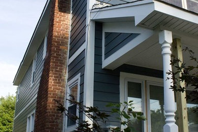 Mid-sized elegant gray two-story concrete fiberboard exterior home photo in Newark with a tile roof