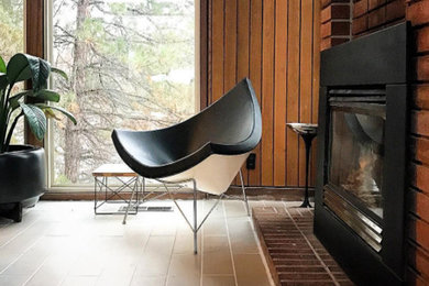Mid-sized mid-century modern formal and open concept porcelain tile and brown floor living room photo in Salt Lake City with brown walls, a standard fireplace, a metal fireplace and no tv