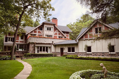 Huge elegant beige two-story mixed siding exterior home photo in Milwaukee with a shingle roof