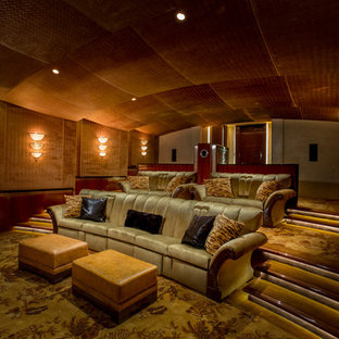 Photo of a mediterranean enclosed home cinema in San Francisco with orange walls, carpet, a projector screen and multi-coloured floors.