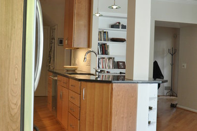 Inspiration for a small galley light wood floor kitchen remodel in New York with flat-panel cabinets and light wood cabinets