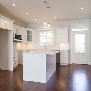 Inspiration for a kitchen pantry in Other with a double-bowl sink, white cabinets, quartz benchtops, white splashback, ceramic splashback, stainless steel appliances, dark hardwood floors, with island, brown floor, yellow benchtop and shaker cabinets.
