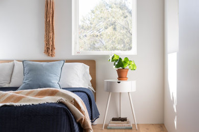 Bedroom - mid-sized scandinavian master light wood floor and brown floor bedroom idea in Denver with white walls and no fireplace