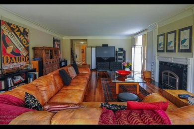 Large eclectic enclosed family room photo in Other with a standard fireplace and a stone fireplace