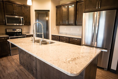 Eat-in kitchen - mid-sized l-shaped medium tone wood floor eat-in kitchen idea in Other with an undermount sink, recessed-panel cabinets, medium tone wood cabinets, quartz countertops, stone slab backsplash, stainless steel appliances and an island