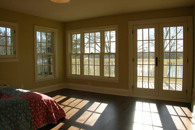 Modernes Hauptschlafzimmer mit beiger Wandfarbe, braunem Holzboden und braunem Boden in Minneapolis