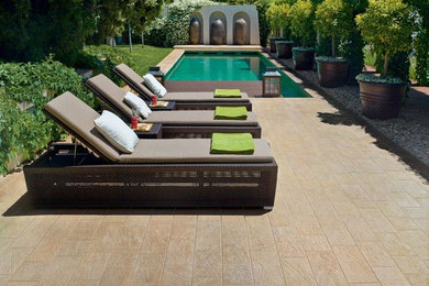 Example of a mid-sized trendy backyard tile and rectangular lap pool design in Dallas
