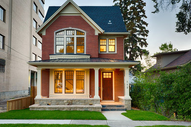 Photo of a mid-sized traditional two-storey brick red exterior in Calgary.