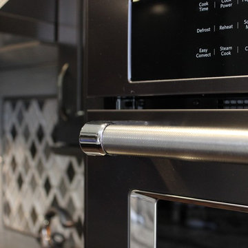DuraSupreme Peppercorn Kitchen With Cambria Tops and Black Stainless Appliances