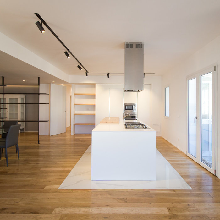 Inspiration for a contemporary single-wall light wood floor and brown floor open concept kitchen remodel in Catania-Palermo with a single-bowl sink, flat-panel cabinets, white cabinets, quartzite coun