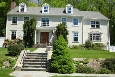 Inspiration for a large timeless white two-story house exterior remodel in New York with a hip roof and a shingle roof