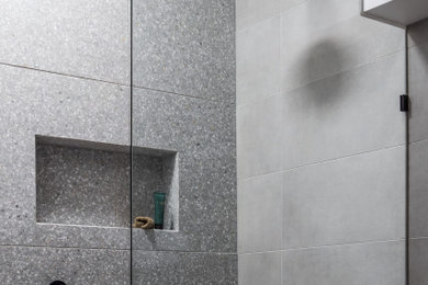Inspiration for a small modern bathroom in Melbourne with an open shower, gray tile, stone tile, grey walls, ceramic floors, grey floor, an open shower and a niche.