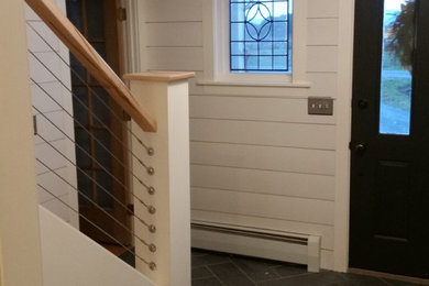 This is an example of a medium sized rural foyer in Burlington with white walls, slate flooring, a single front door and a green front door.