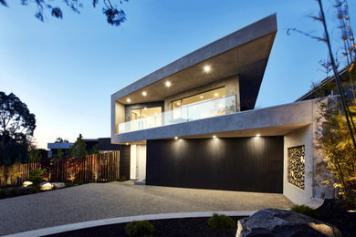 Inspiration for a large contemporary concrete house exterior in Melbourne with a flat roof.