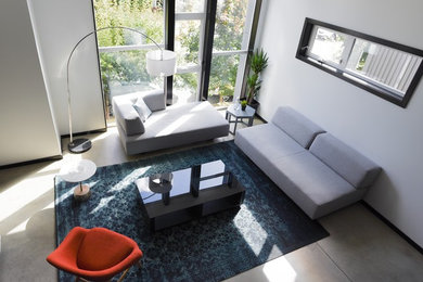 Living room - large modern formal and enclosed concrete floor and gray floor living room idea in Seattle with white walls, no fireplace and no tv