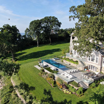 vanishing edge glass wall pool + raised perimeter overflow spa
