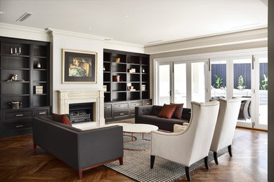 Inspiration for a large transitional open concept living room in Melbourne with beige walls, a standard fireplace, a stone fireplace surround, a built-in media wall, brown floor and dark hardwood floors.