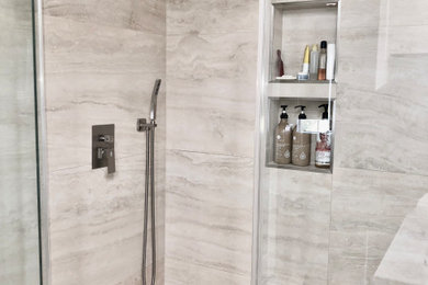 Inspiration for a mid-sized master gray tile and porcelain tile porcelain tile, gray floor and double-sink bathroom remodel in Orange County with shaker cabinets, white cabinets, quartz countertops, a hinged shower door, gray countertops and a freestanding vanity