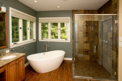 Bathroom - mid-sized modern master brown tile and ceramic tile ceramic tile and brown floor bathroom idea in Other with an undermount sink, raised-panel cabinets, medium tone wood cabinets, granite countertops, gray walls and a hinged shower door