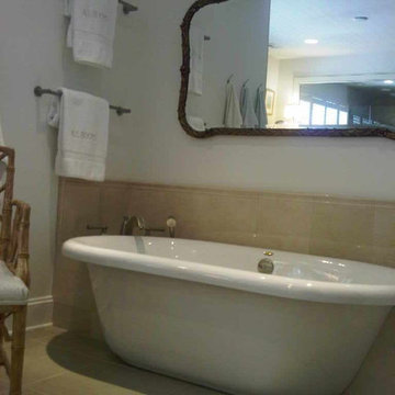free standing tub with an antique mirror above