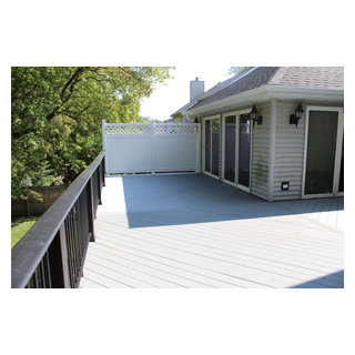 Raised Stone Ash Timbertech Deck with White Vinyl Privacy Fence in ...