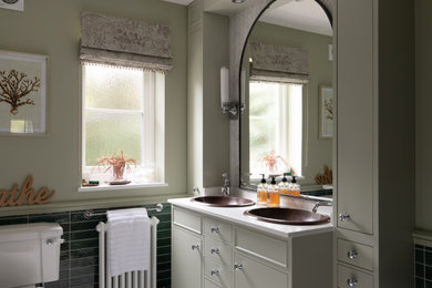 Mid-sized country master bathroom in Surrey with flat-panel cabinets, green cabinets, a freestanding tub, a one-piece toilet, green tile, porcelain tile, green walls, porcelain floors, a drop-in sink, quartzite benchtops, white floor, white benchtops, a double vanity and a built-in vanity.