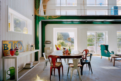 Photo of an expansive industrial dining room in Barcelona with white walls, concrete floors and no fireplace.