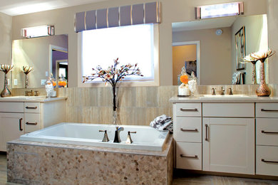 Example of a transitional beige tile and porcelain tile porcelain tile and beige floor drop-in bathtub design in Other with flat-panel cabinets, white cabinets, beige walls, a drop-in sink and beige countertops