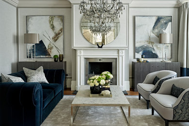 Inspiration for a transitional formal enclosed living room in London with no tv, a standard fireplace and grey walls.
