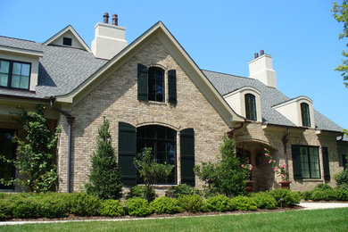 Example of a large classic two-story brick exterior home design in Other