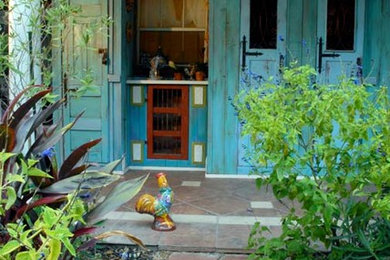 Inspiration for a mid-sized farmhouse backyard tile patio remodel in Houston with a roof extension